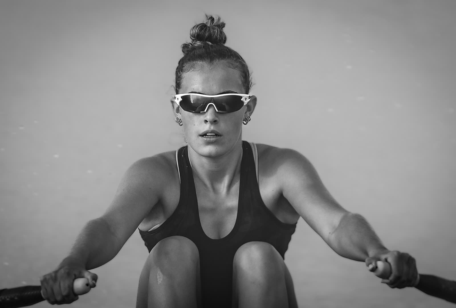 Athlete focused mid-stroke on the erg