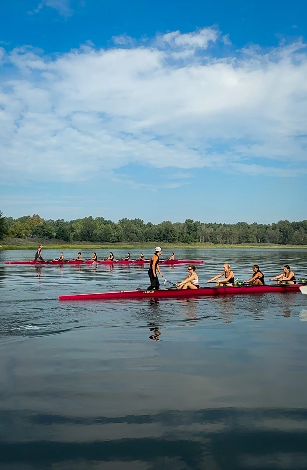Crews stacked up the river in red boats