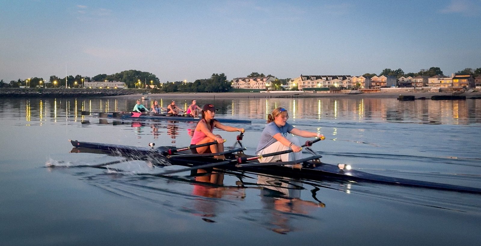 A quad in pink and blue on calm water in the early light