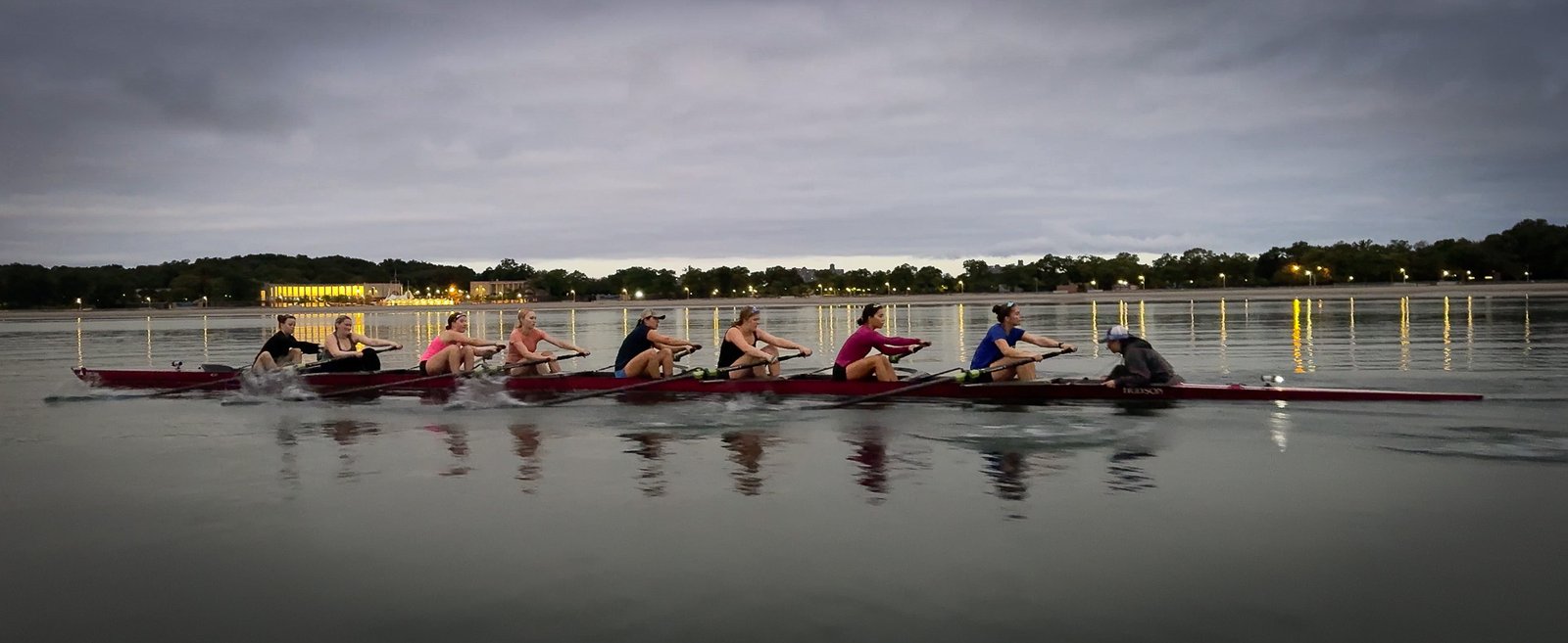 An eight on the water at dusk