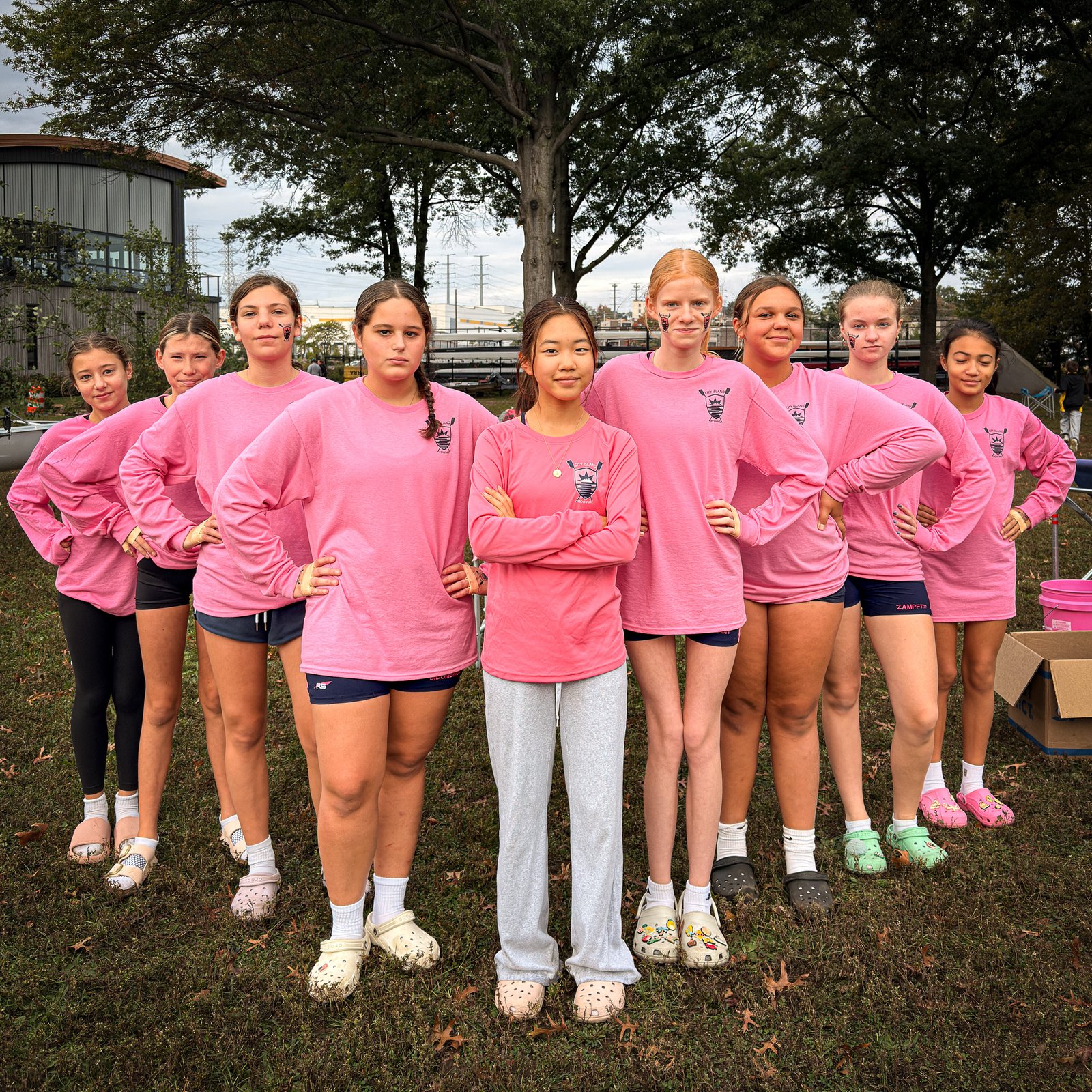 A group in pink long sleeves on the grass