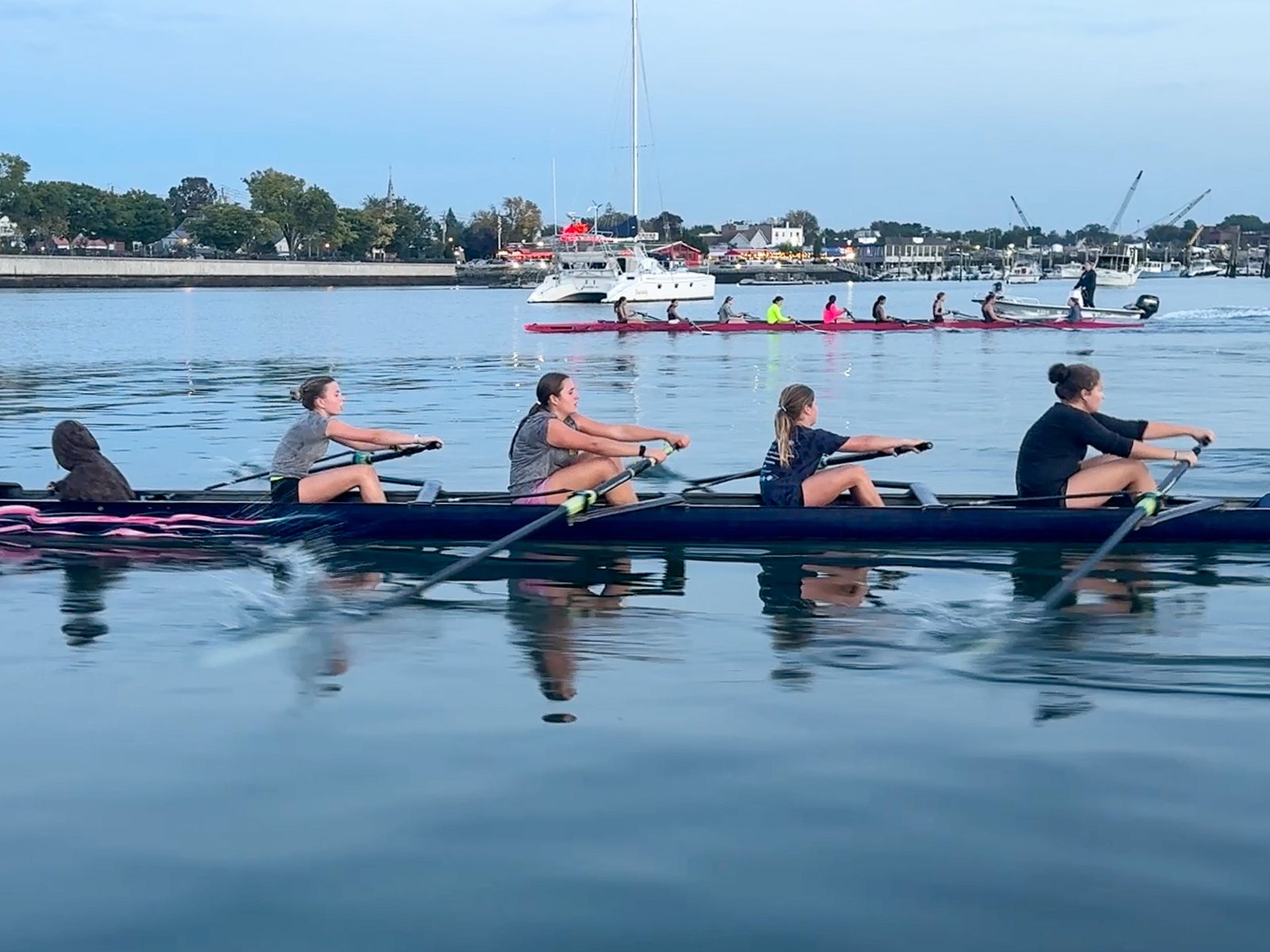 A quad on the water with the marina behind it