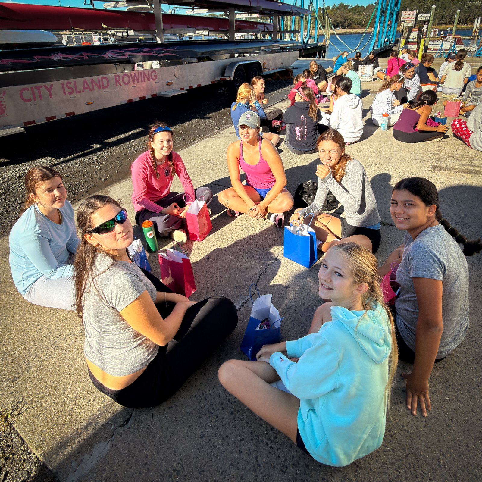 A sister group sitting together on the dock
