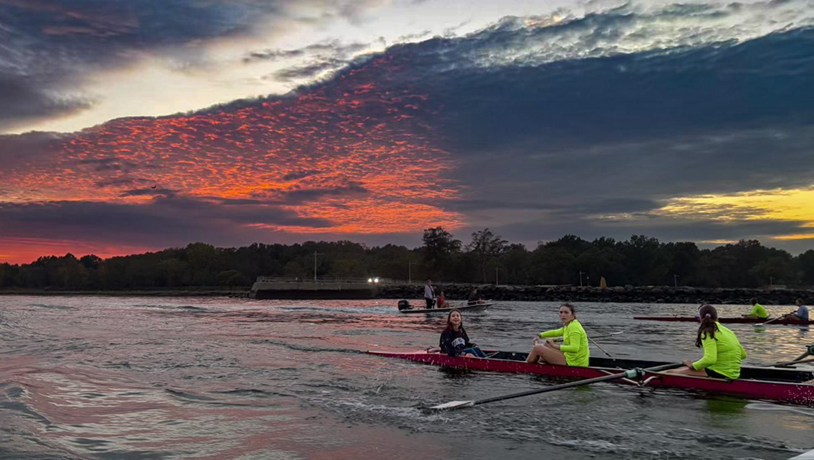 Two crews in hi-vis under a sunset sky